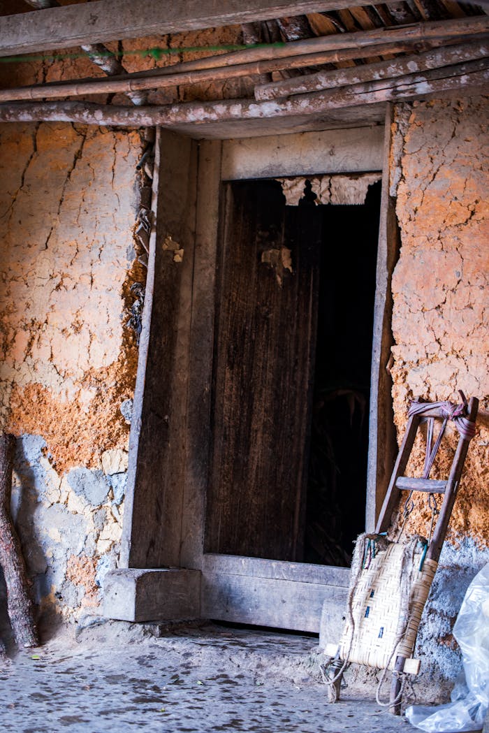 An aged mud house entrance showing neglect and rustic charm.